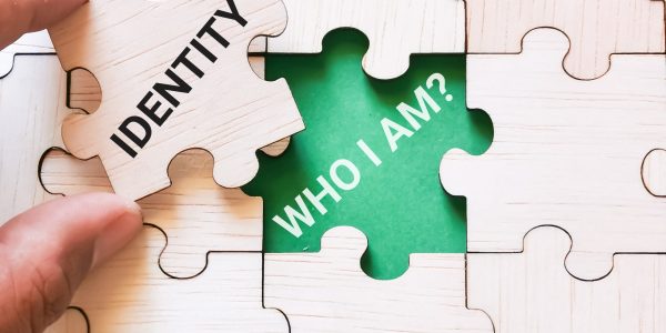 Phrase identity who i am on jigsaw puzzles with hand hold one piece.